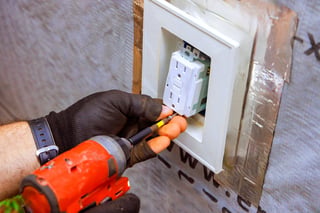 Electrician using multimeter to test electrical circuit